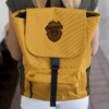 an canvas backpack with faux leather patch logo