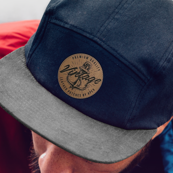 Black cap with brown faux leather patch logo