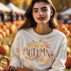 Woman wearing polyester sweatshirt with fall sublimation transfer by Apex Transfers
